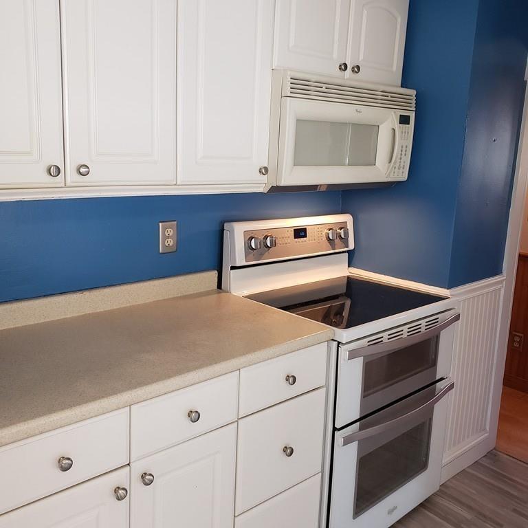 102 Mason Road Dudley, MA 01571 - Photo 8 of 29 a kitchen with granite countertop white cabinets and white appliances