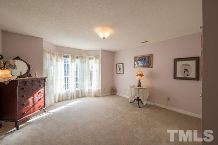 5624 Barham Court Raleigh, NC 27613 - Photo 11 of 19 a living room with furniture and a gate