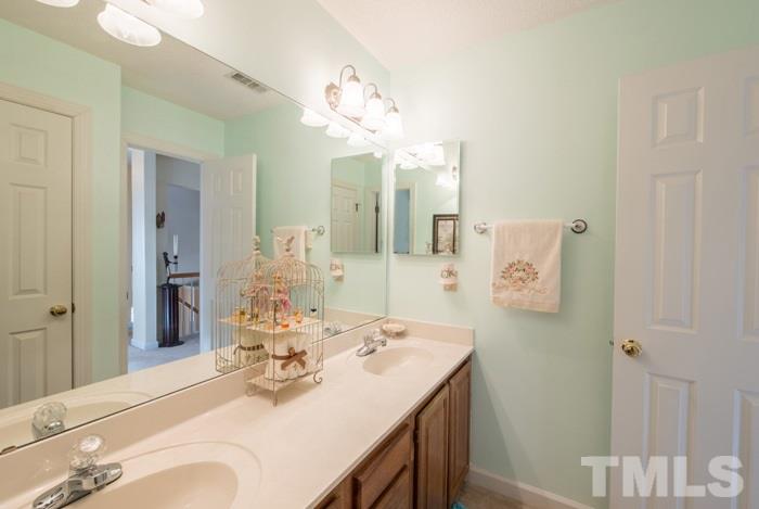 5624 Barham Court Raleigh, NC 27613 - Photo 13 of 19 a bathroom with a sink vanity and a mirror