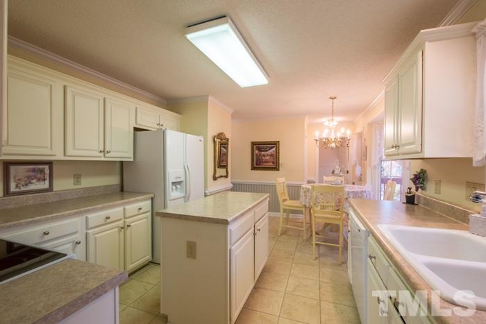5624 Barham Court Raleigh, NC 27613 - Photo 4 of 19 a kitchen with white cabinets and sink