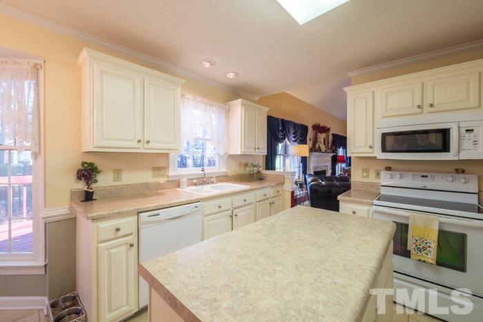 5624 Barham Court Raleigh, NC 27613 - Photo 5 of 19 a kitchen with a stove a sink and a refrigerator