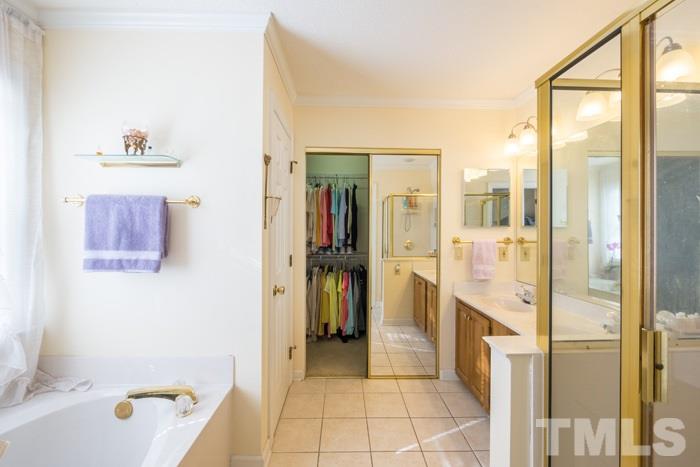 5624 Barham Court Raleigh, NC 27613 - Photo 8 of 19 a bathroom with a tub and shower