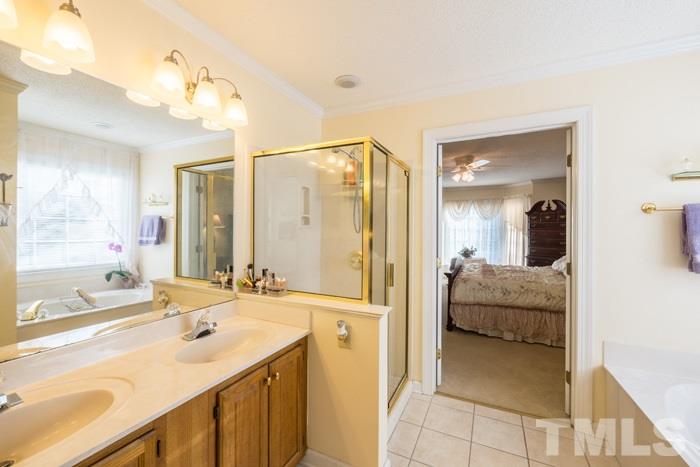 5624 Barham Court Raleigh, NC 27613 - Photo 9 of 19 a en suite bathroom with a tub sink and mirror