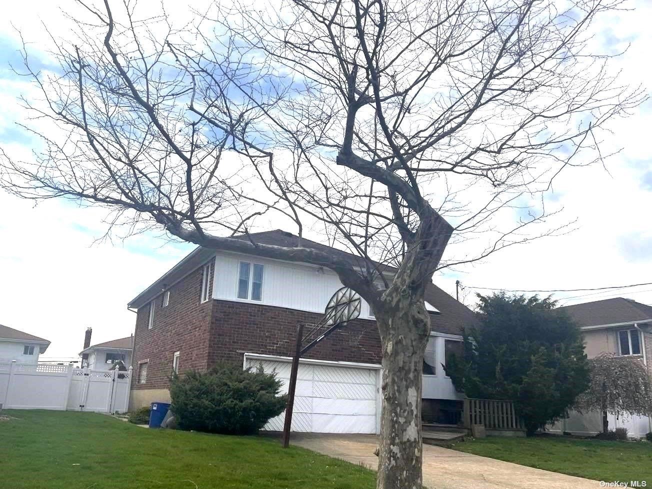 a house that has a tree in front of the house