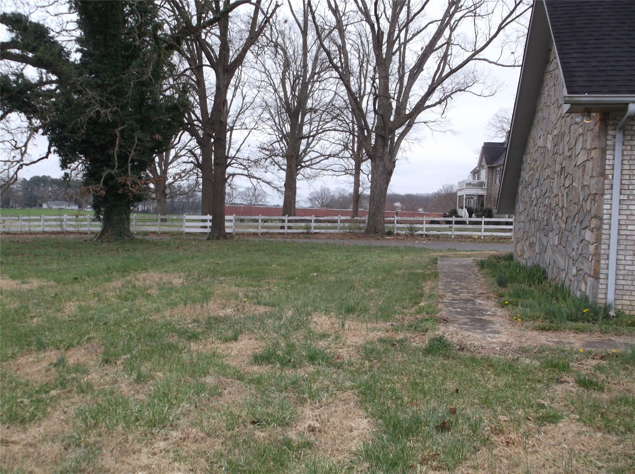 6614 Medlin Road Monroe, NC 28112 - Photo 4 of 14 a backyard of apartments with large trees