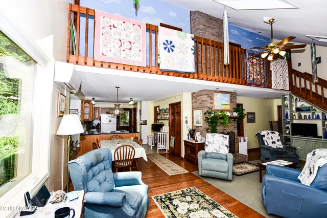 a living room with furniture a fireplace and lots of windows