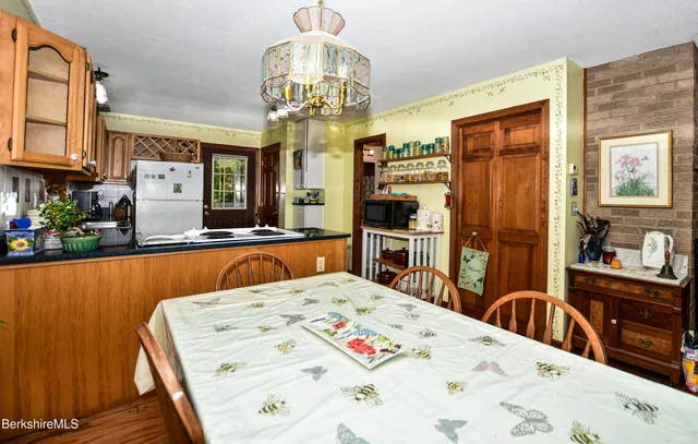 a view of kitchen island dining table and wooden floor