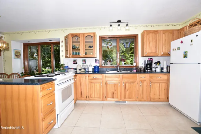 a kitchen with stainless steel appliances granite countertop a stove and a refrigerator