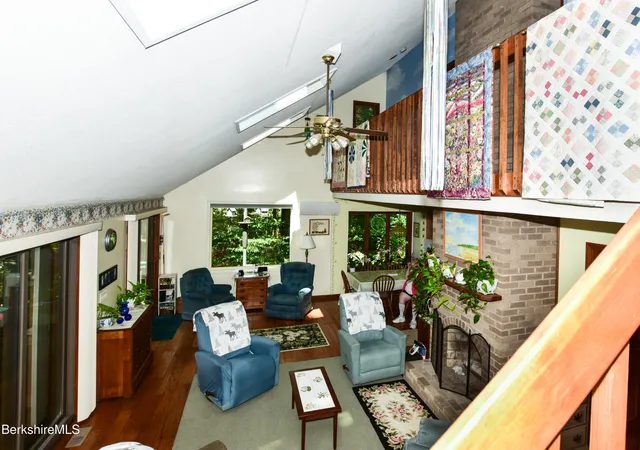 a living room with furniture plant and a large window
