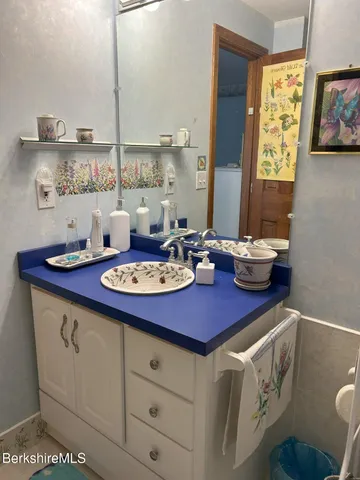 a view of a kitchen area with furniture and wooden floor