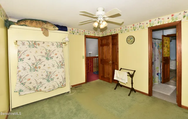 walk in closet with window and a bathroom