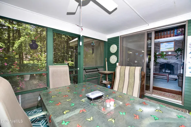 a dining room with furniture and a floor to ceiling window