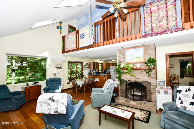 a living room with furniture fireplace and a large window