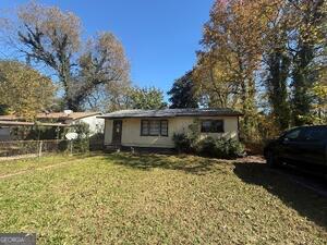 a view of a backyard with a large tree