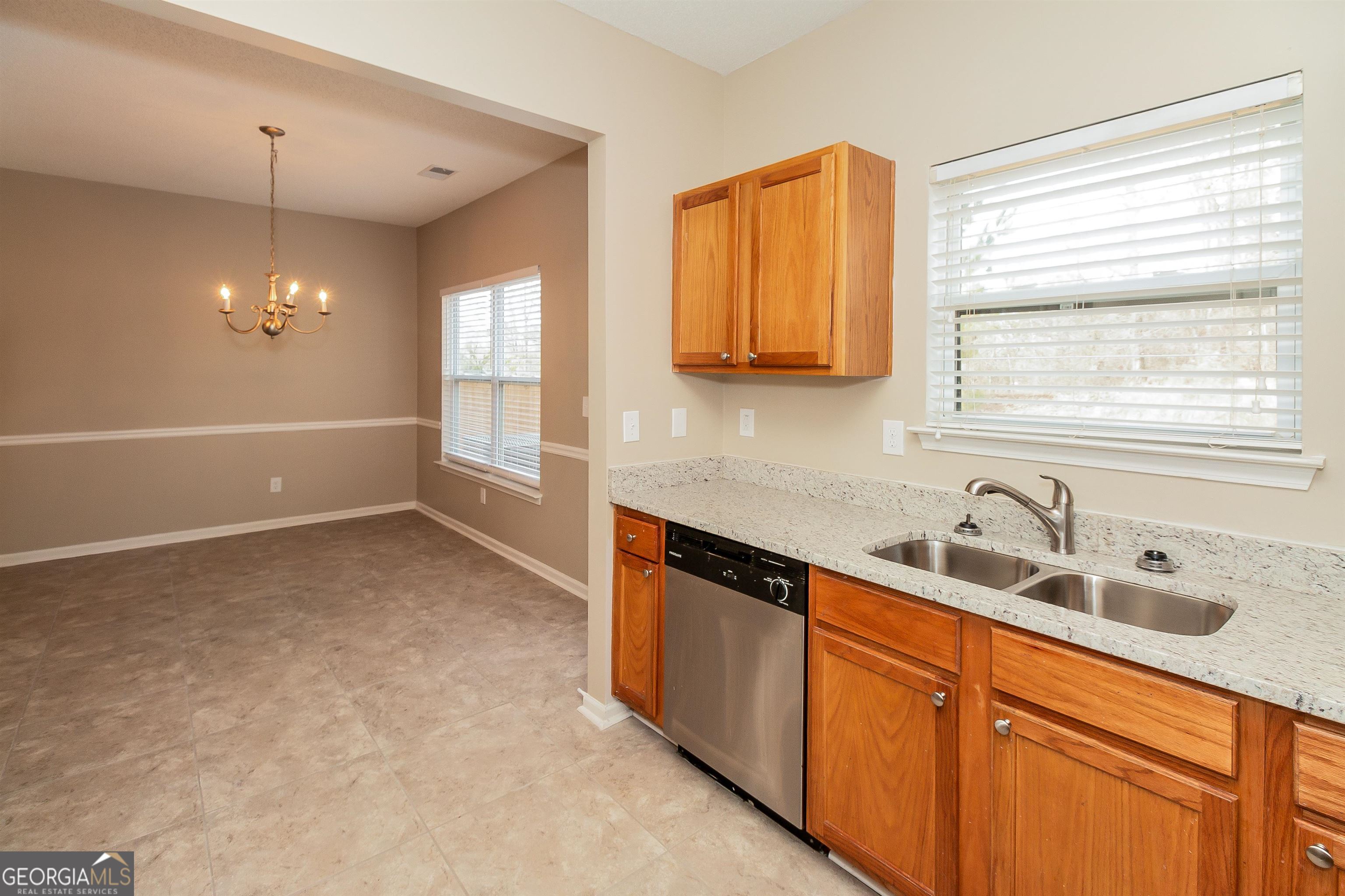 2413 Hackamore Drive Atlanta, GA 30349 - Photo 12 of 15 a kitchen with a sink and a window