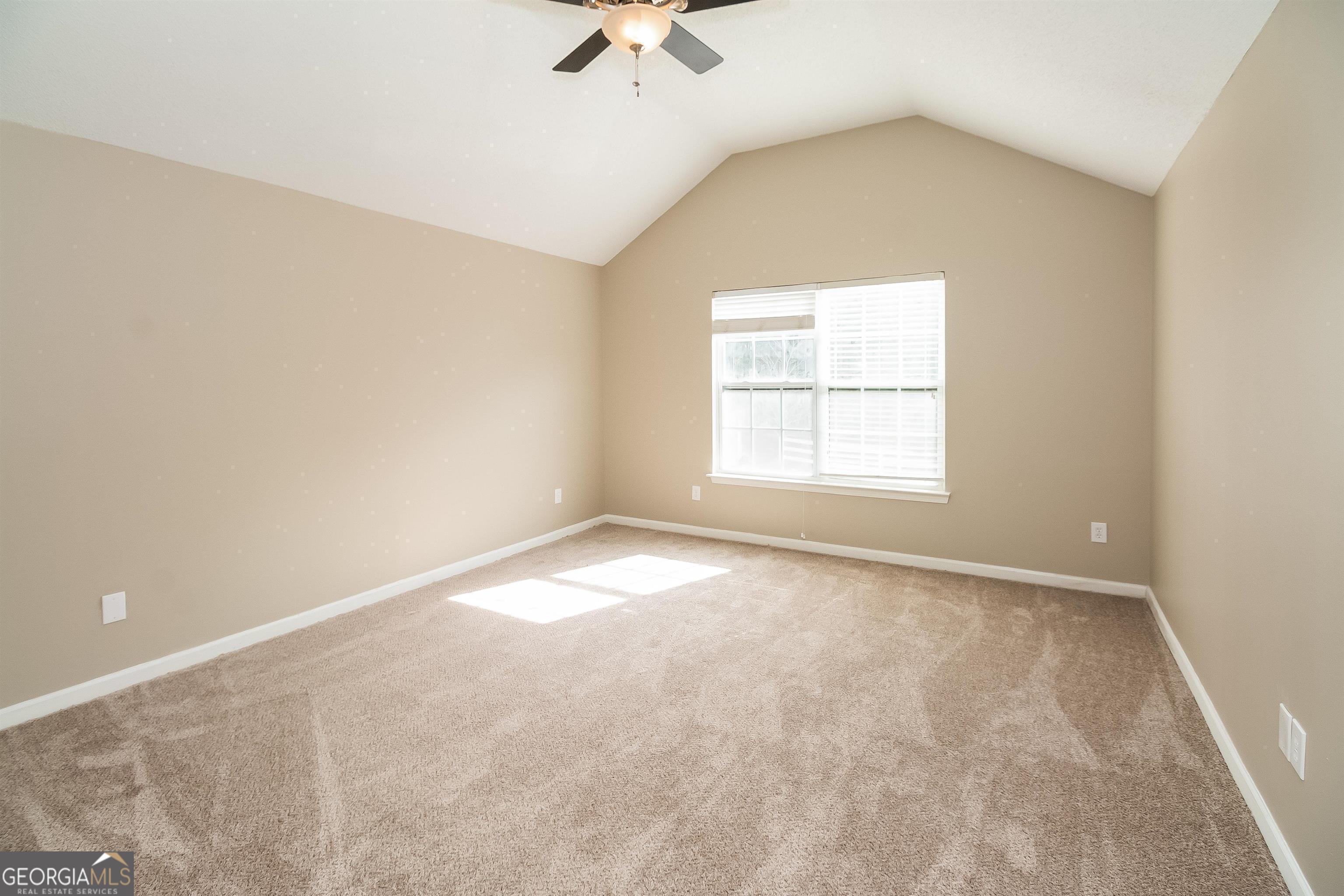 2413 Hackamore Drive Atlanta, GA 30349 - Photo 13 of 15 an empty room with a window and a ceiling fan