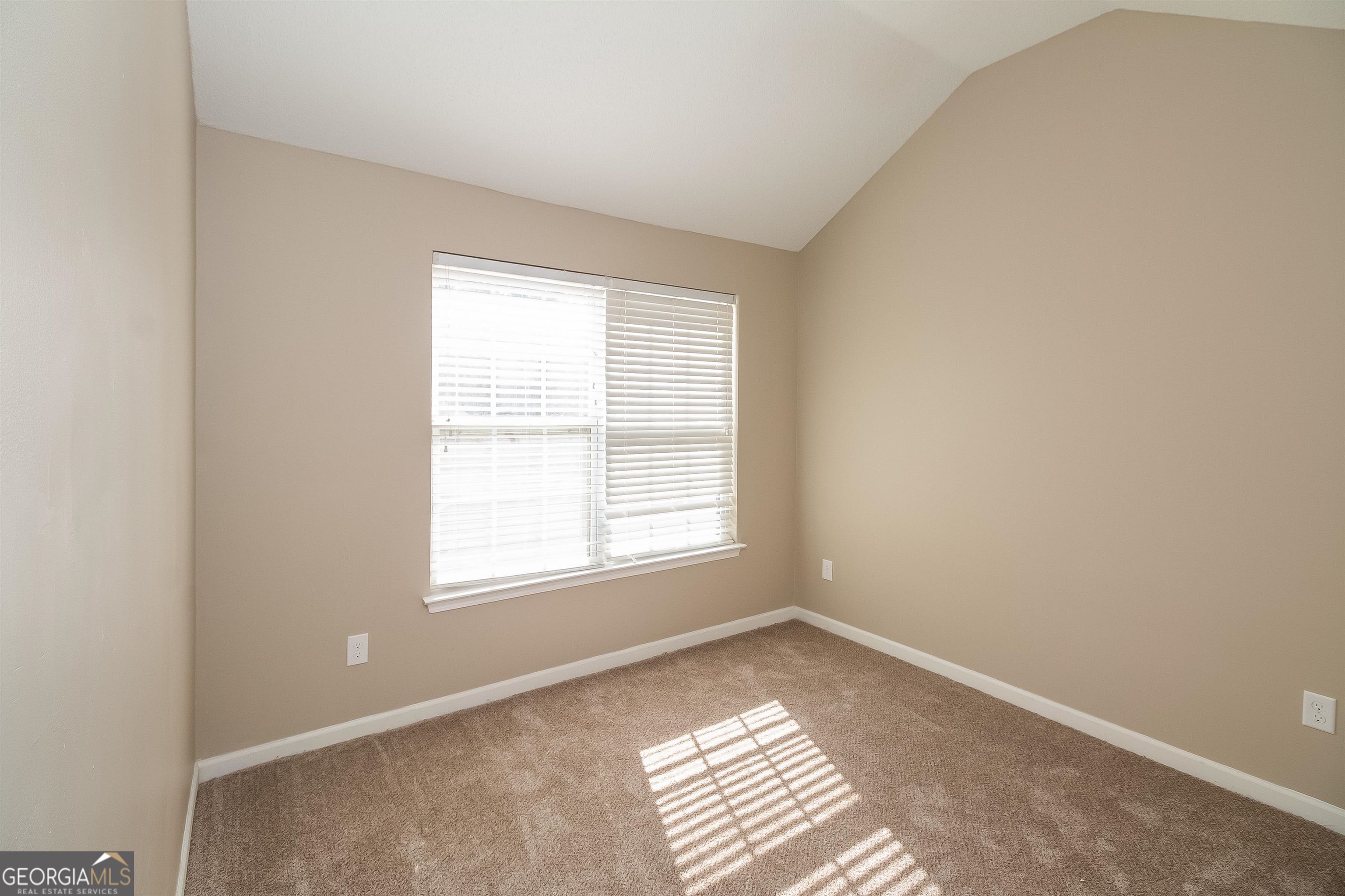 2413 Hackamore Drive Atlanta, GA 30349 - Photo 2 of 15 a view of an empty room with a window