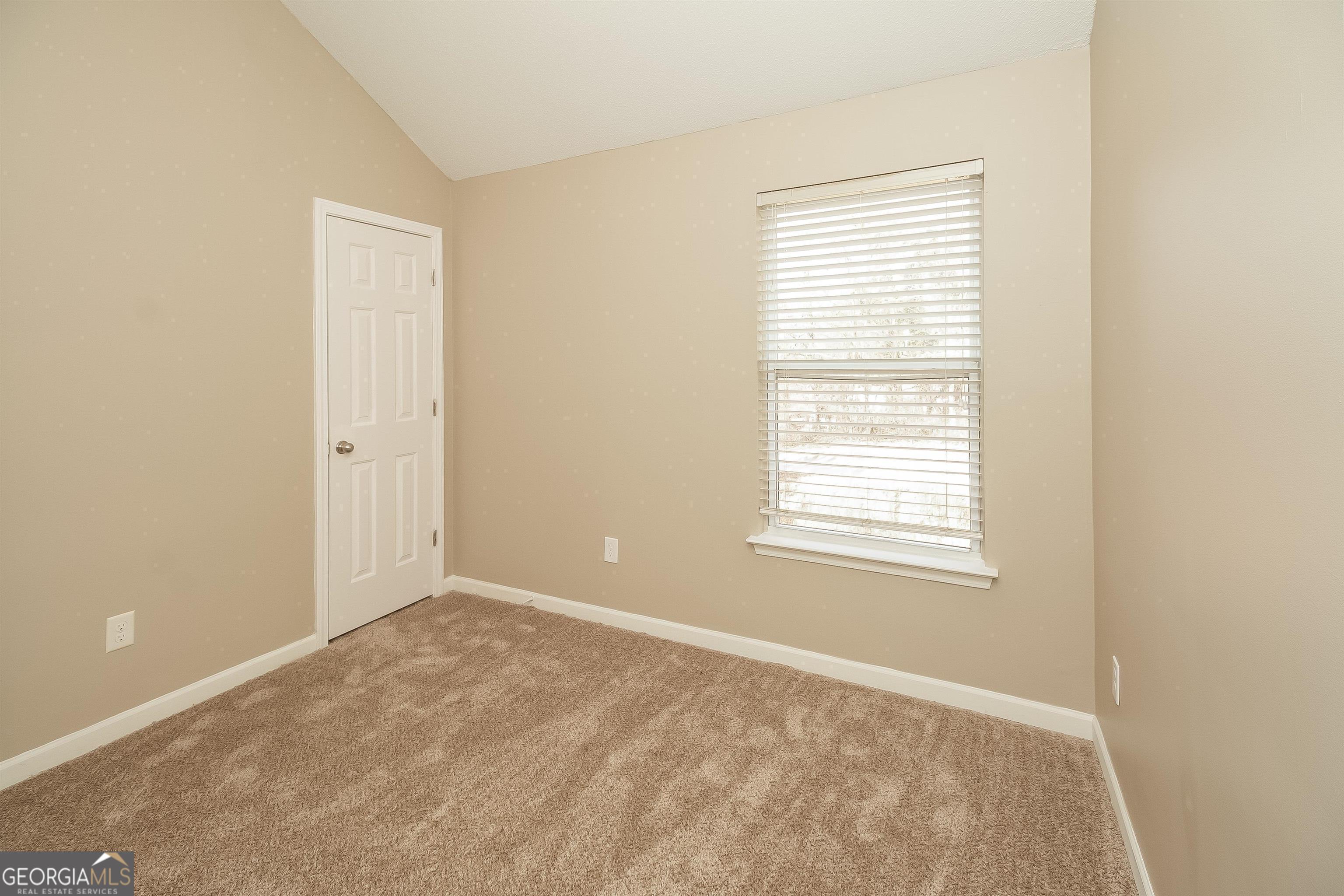 2413 Hackamore Drive Atlanta, GA 30349 - Photo 4 of 15 a view of an empty room with a window