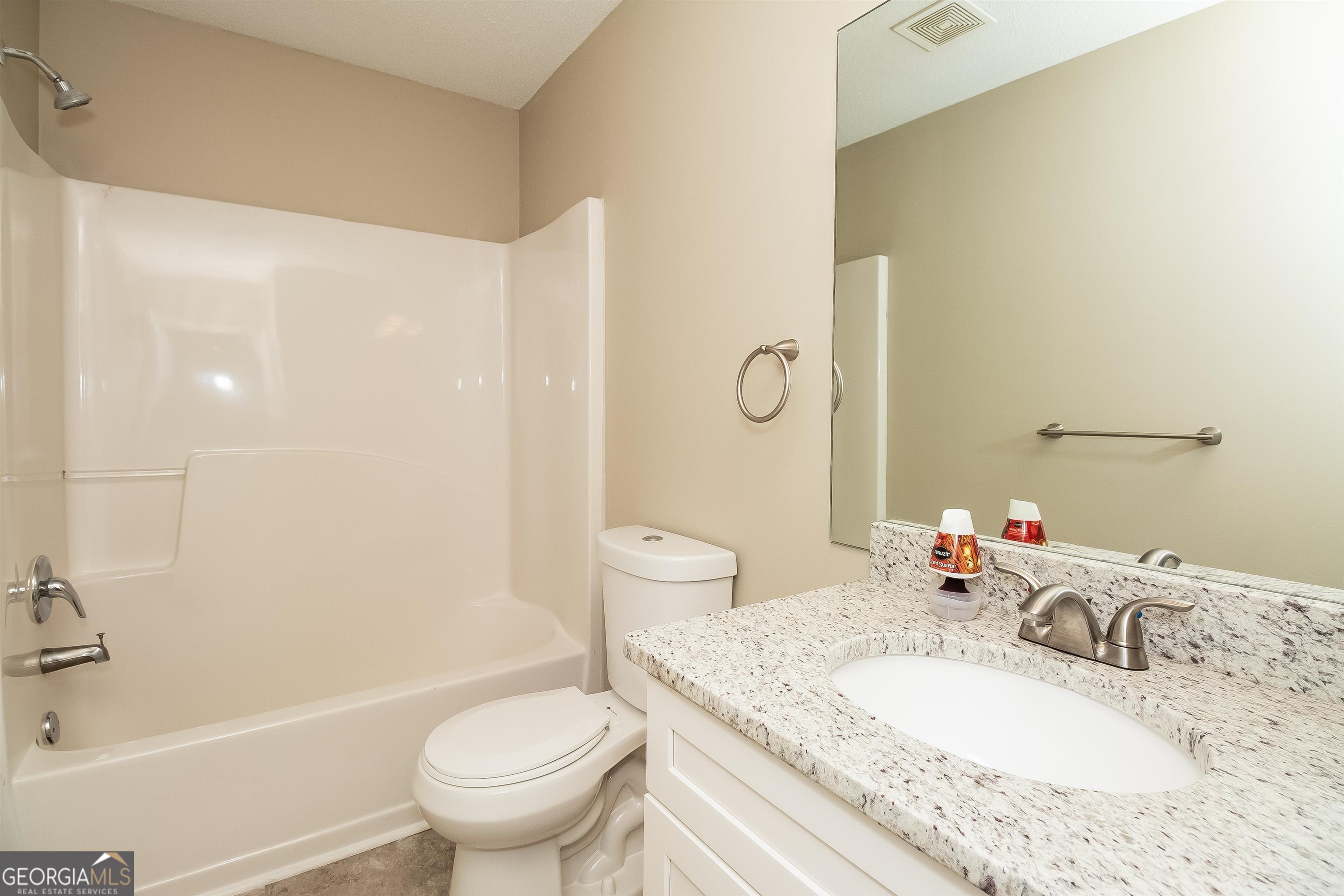 2413 Hackamore Drive Atlanta, GA 30349 - Photo 5 of 15 a bathroom with a granite countertop sink a toilet and a bathtub