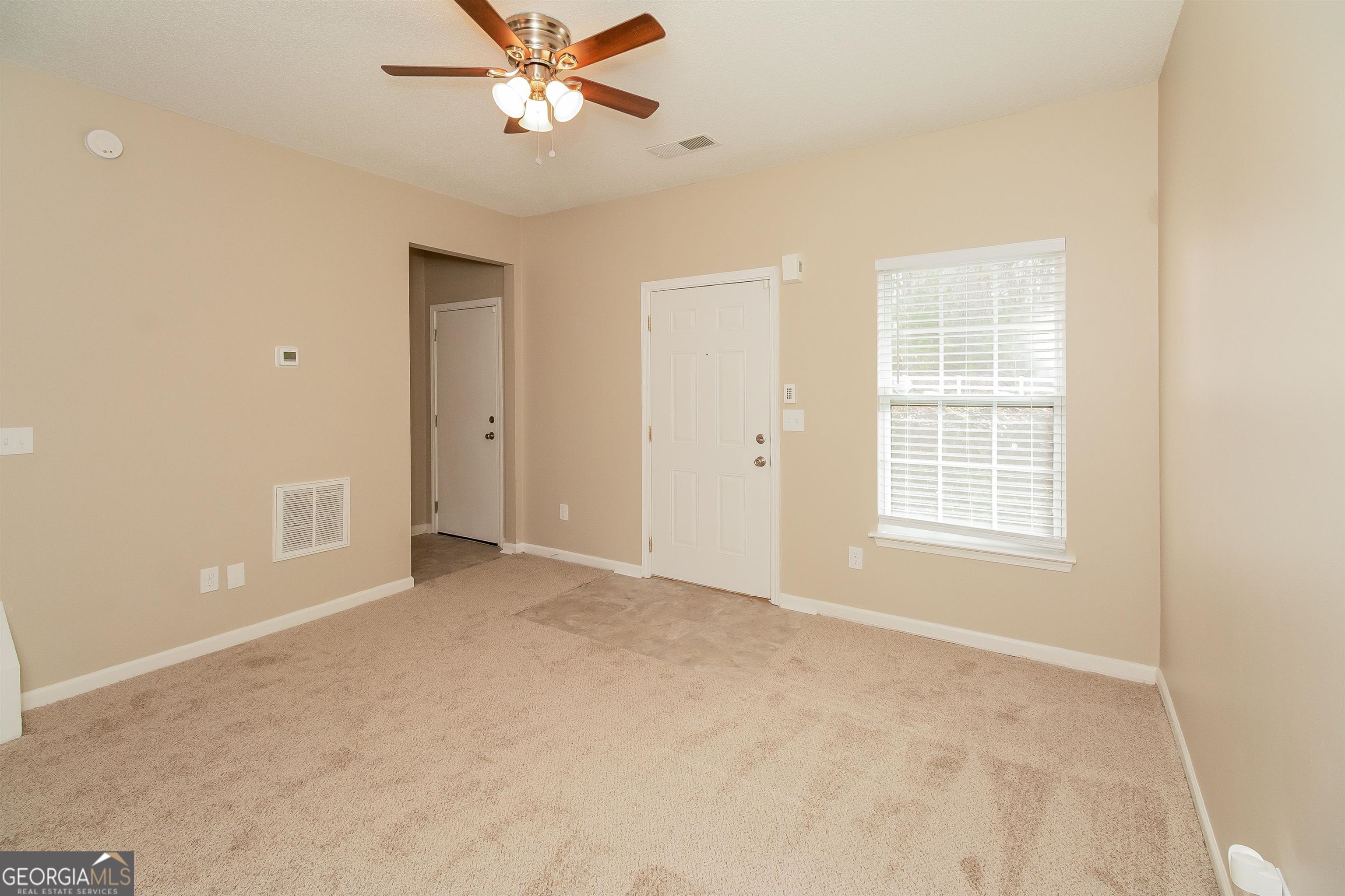 2413 Hackamore Drive Atlanta, GA 30349 - Photo 6 of 15 a view of an empty room with a window