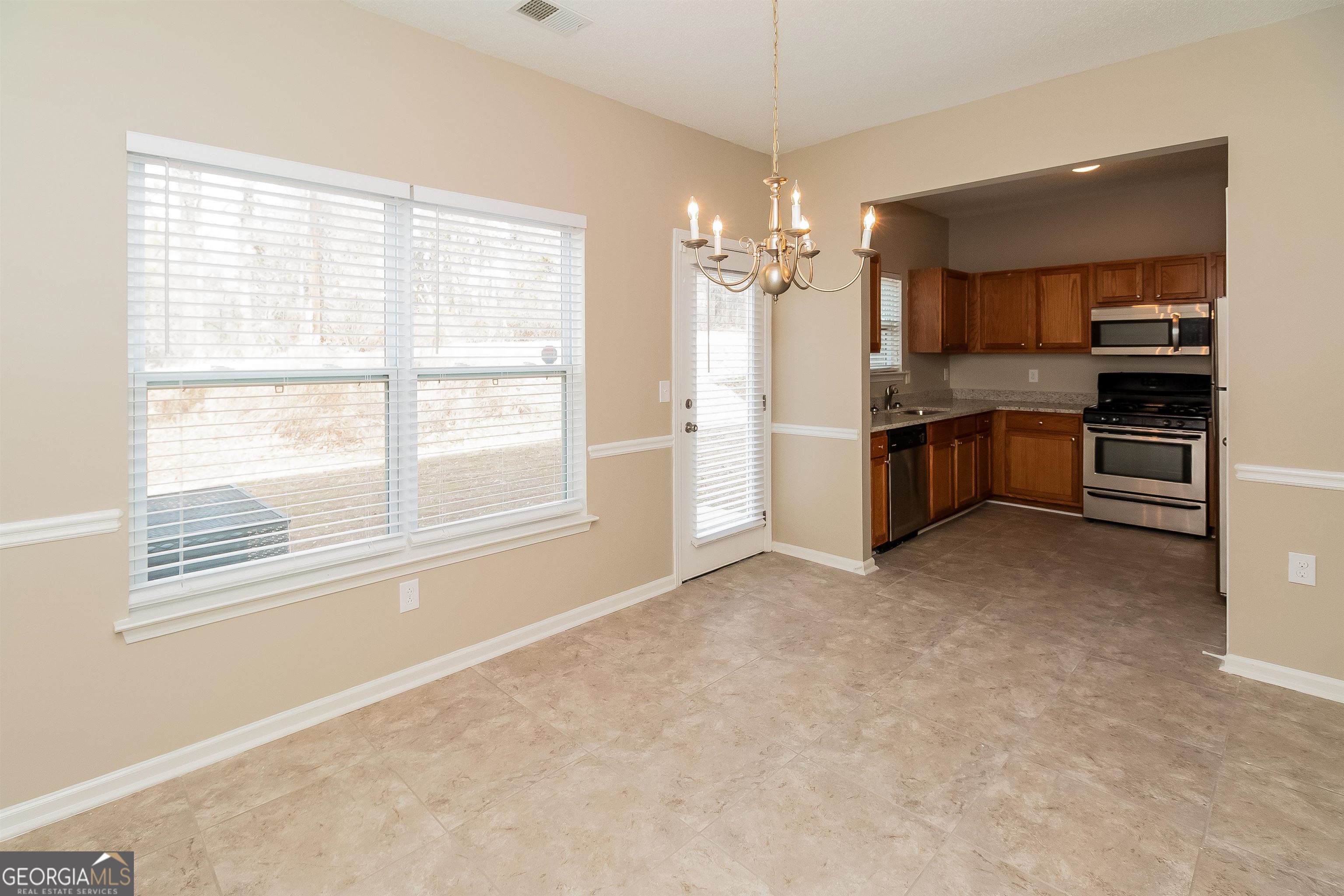 2413 Hackamore Drive Atlanta, GA 30349 - Photo 10 of 15 a view of a kitchen with a sink and a stove top oven