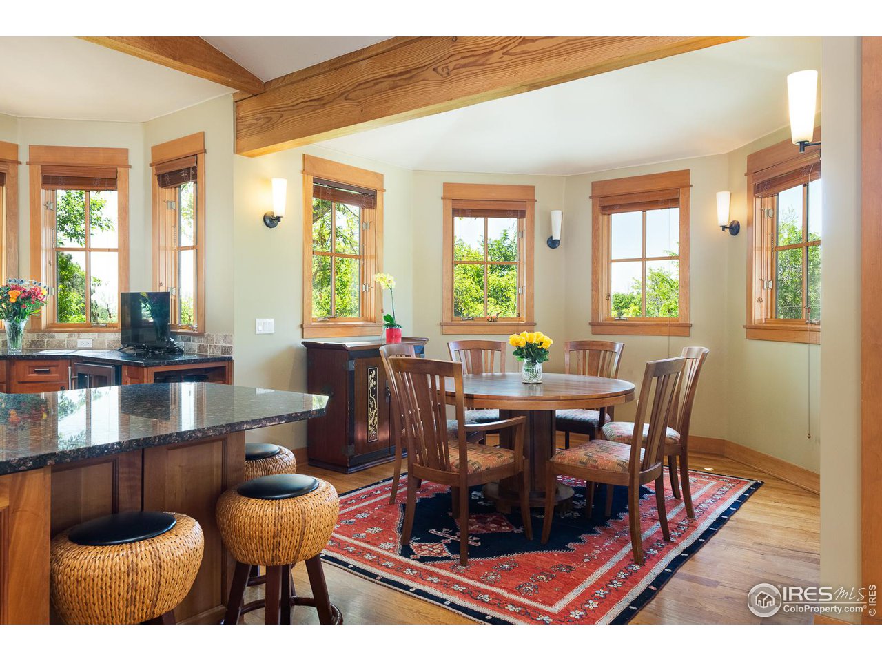 520 Spruce Street Boulder, CO 80302 - Photo 13 of 40 a dining room with furniture a rug a potted plant and a chandelier