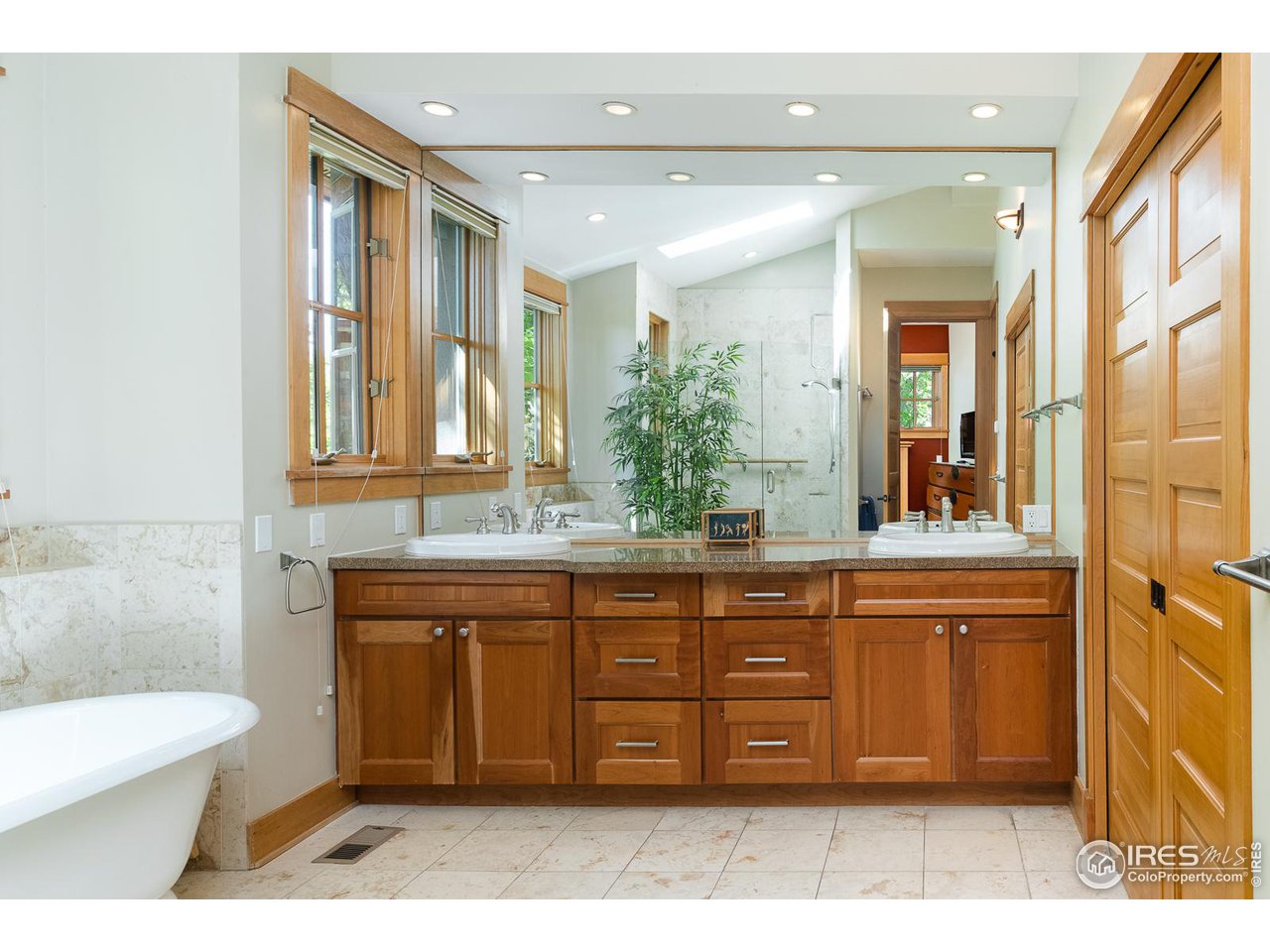 520 Spruce Street Boulder, CO 80302 - Photo 21 of 40 a spacious bathroom with a granite countertop sink a mirror and a bathtub