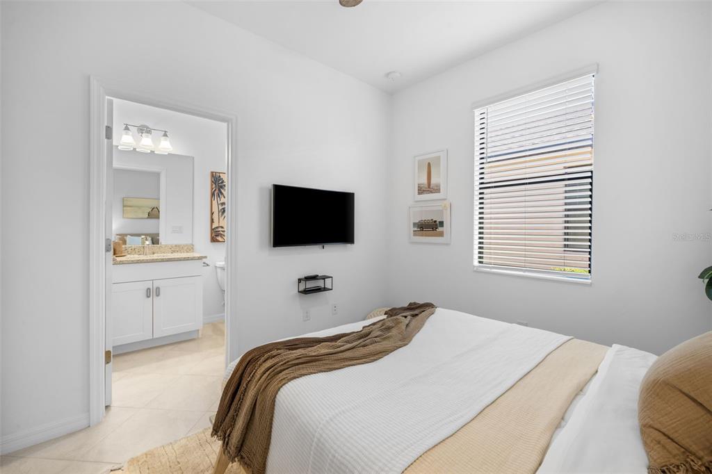 1842 West Isles Road Port Charlotte, FL 33953 - Photo 34 of 65 a bedroom with a bed and a flat screen tv