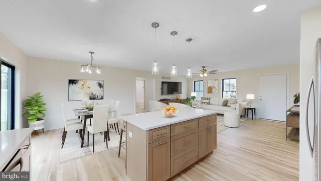 a large kitchen with sink a counter space and stainless steel appliances