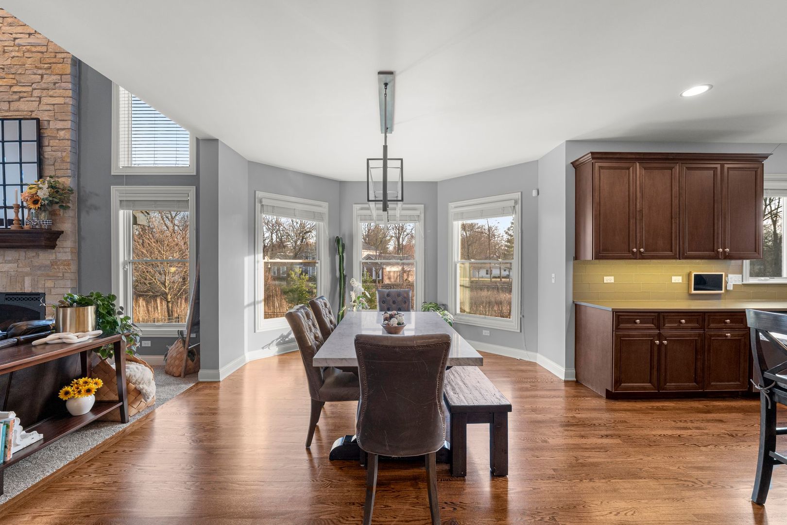 81 Landon Circle Wheaton, IL 60189 - Photo 17 of 79 a dining room with wooden floor a chandelier a glass table and chairs