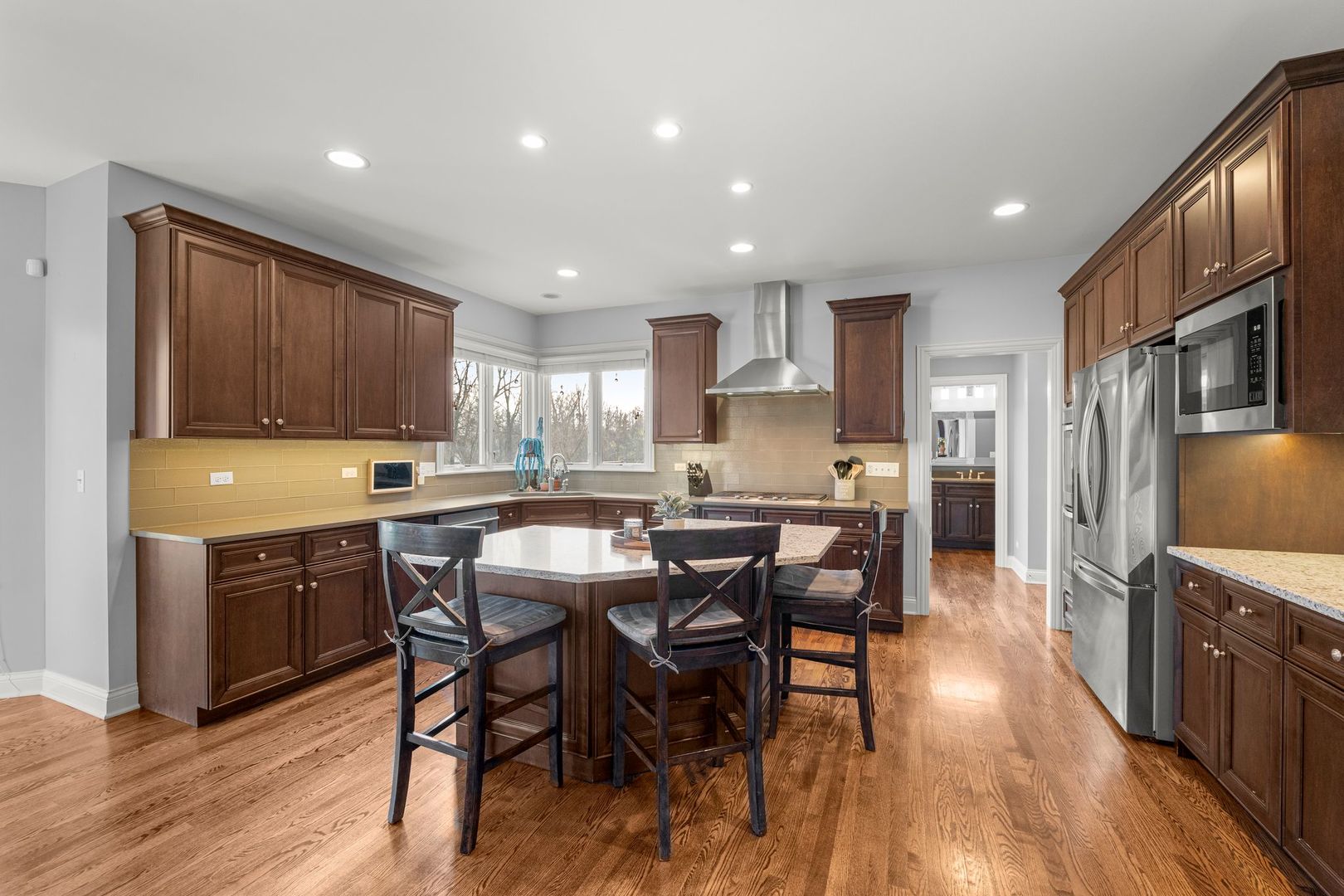 81 Landon Circle Wheaton, IL 60189 - Photo 18 of 79 a kitchen with stainless steel appliances granite countertop a table chairs sink refrigerator and cabinets