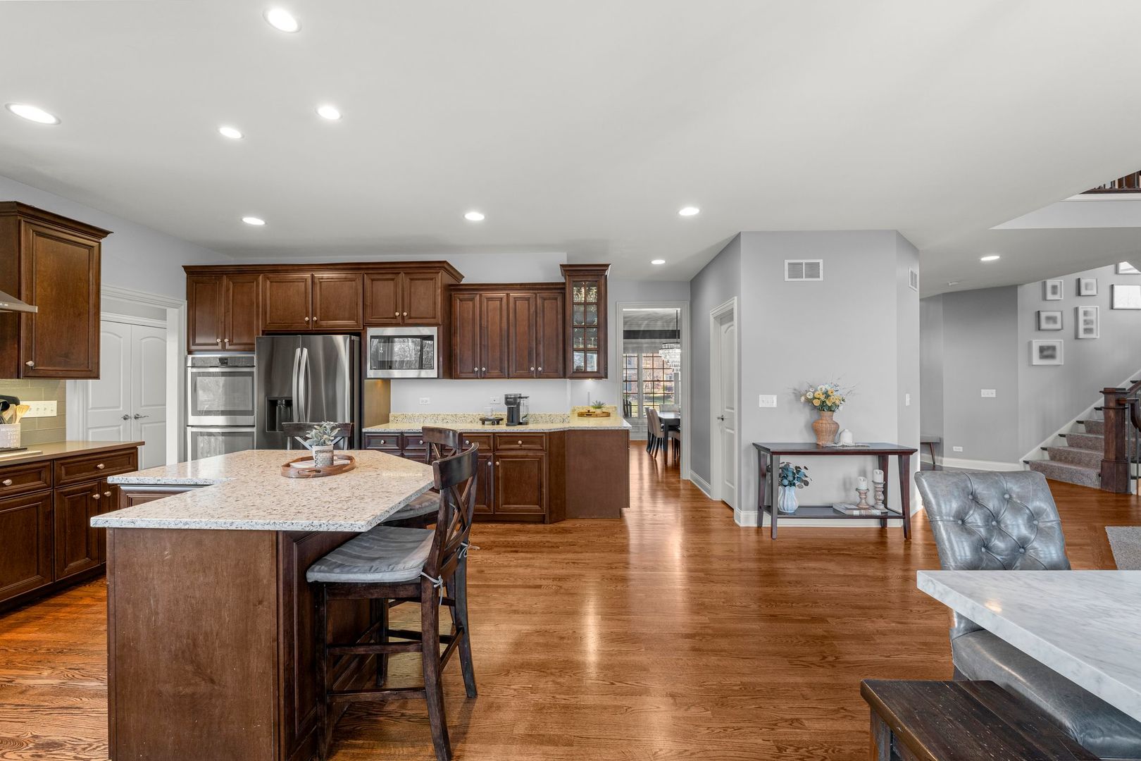 81 Landon Circle Wheaton, IL 60189 - Photo 19 of 79 a large kitchen with kitchen island a dining table and chairs