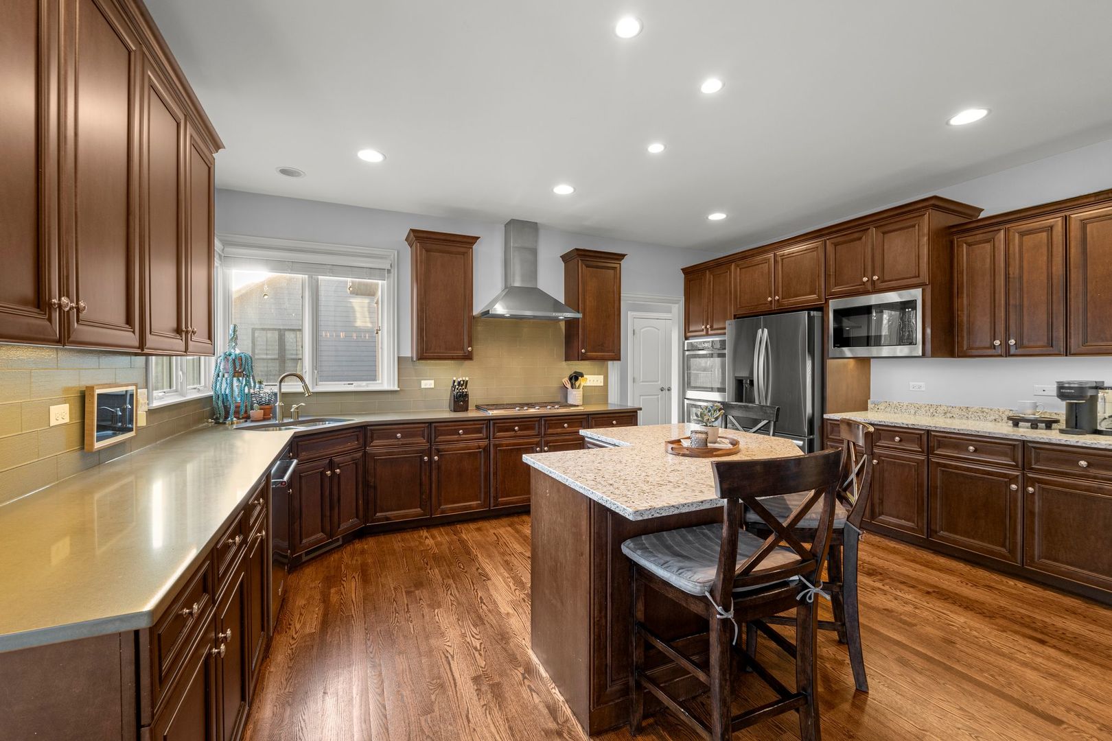81 Landon Circle Wheaton, IL 60189 - Photo 20 of 79 a kitchen with stainless steel appliances granite countertop a stove a sink a microwave a refrigerator cabinets and a dining table