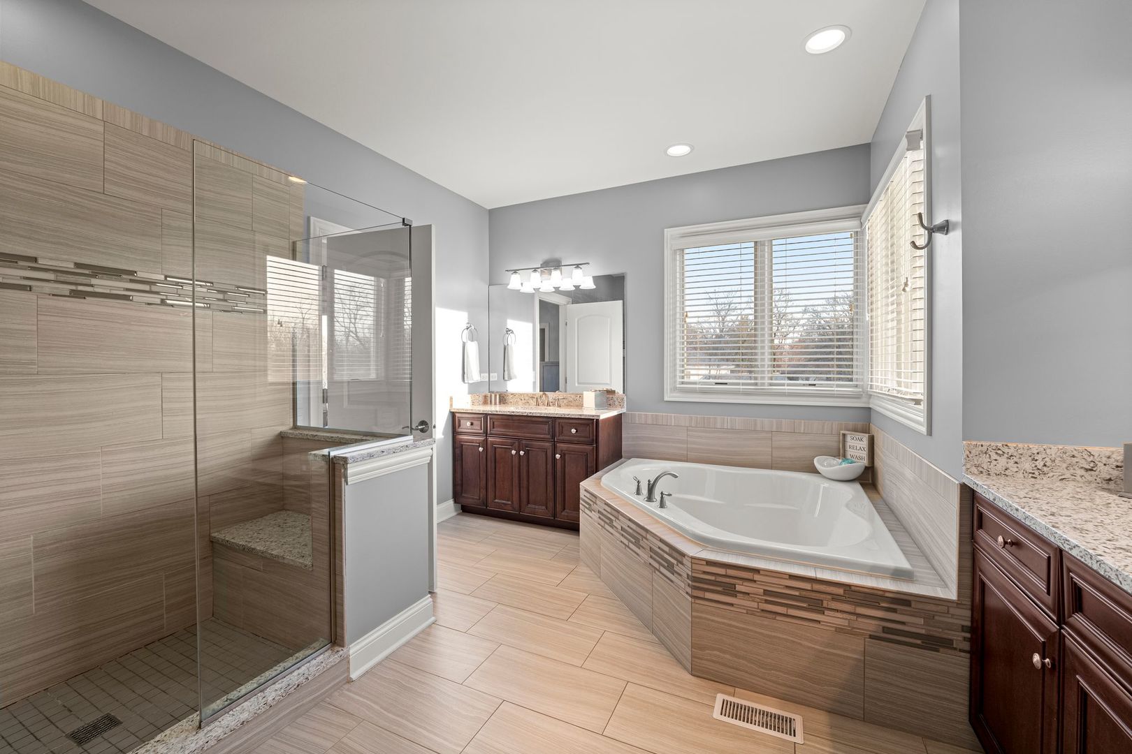 81 Landon Circle Wheaton, IL 60189 - Photo 34 of 79 a bathroom with a tub a sink a mirror and a shower