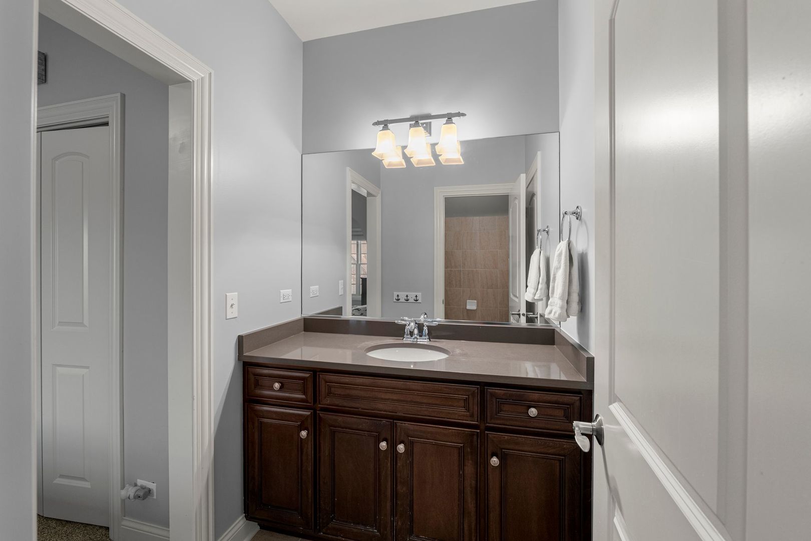 81 Landon Circle Wheaton, IL 60189 - Photo 40 of 79 a bathroom with a sink and a mirror