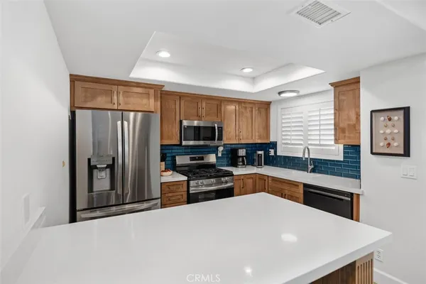 a kitchen with stainless steel appliances a refrigerator stove microwave and sink