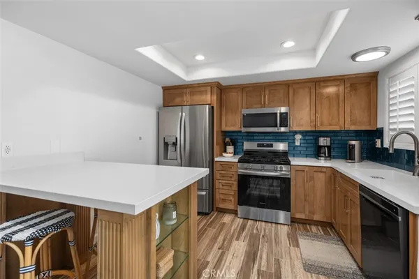 a kitchen with stainless steel appliances a stove microwave and refrigerator
