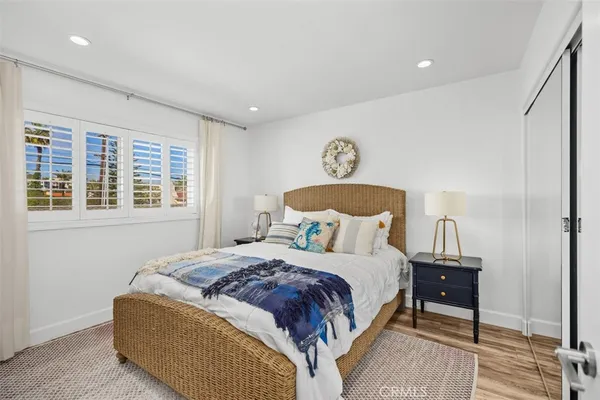 a bedroom with a bed and painting on the wall