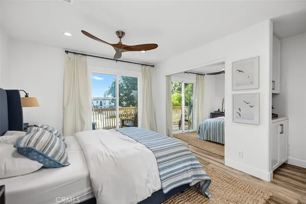 a bedroom with a bed couch and a large window