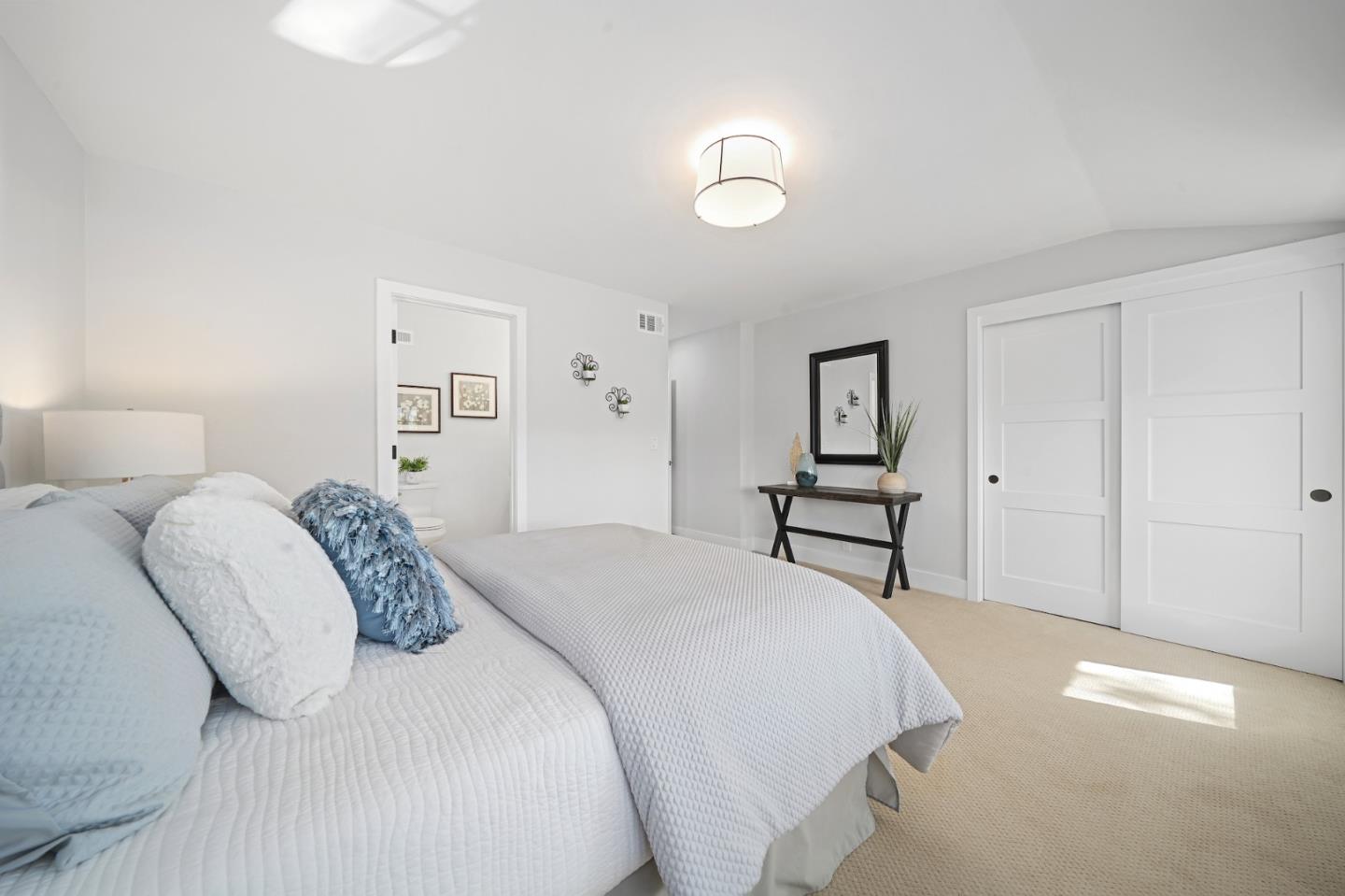 827 Bend Avenue San Jose, CA 95136 - Photo 16 of 27 a bedroom with a bed and a lamp