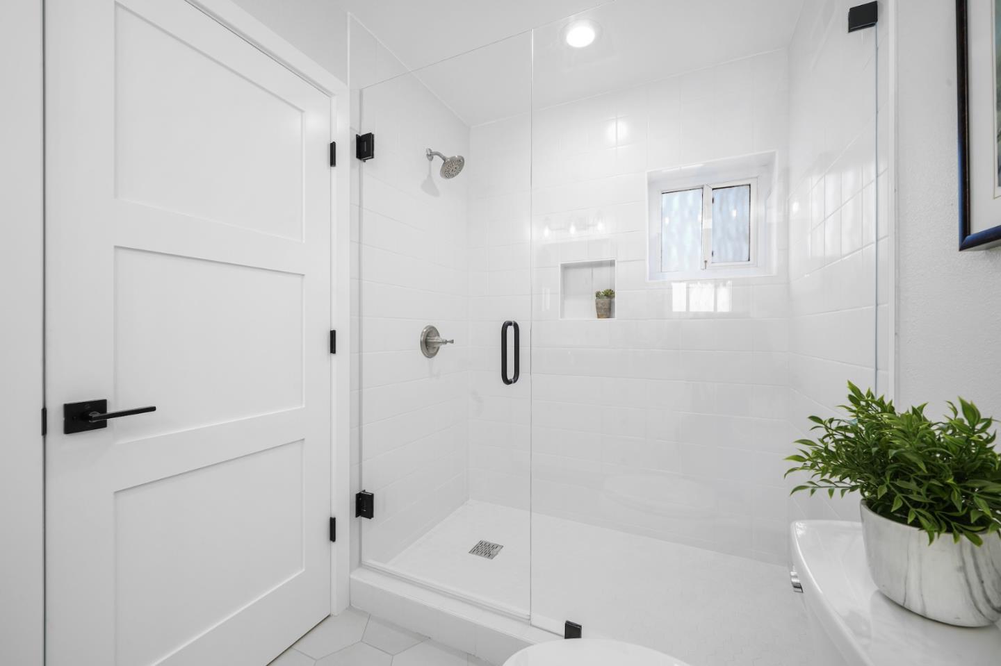 827 Bend Avenue San Jose, CA 95136 - Photo 18 of 27 a bathroom with a tub shower and window