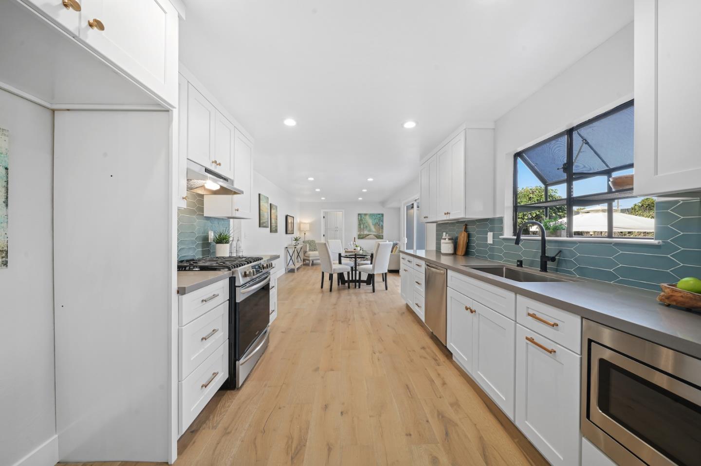 827 Bend Avenue San Jose, CA 95136 - Photo 7 of 27 a large kitchen with stainless steel appliances granite countertop a lot of counter space and wooden floors