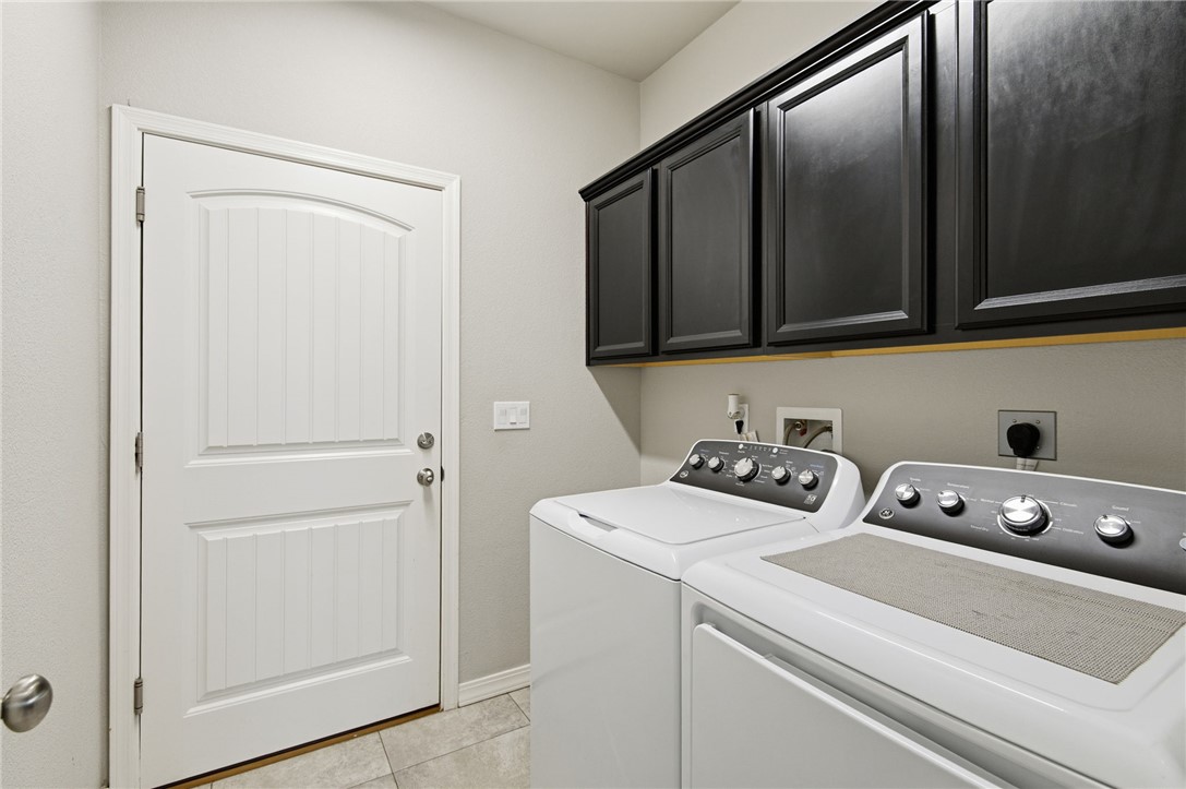 4713 North Old Ranch Lane Kingman, AZ 86401 - Photo 11 of 41 a view of washer and dryer with bathroom in the background