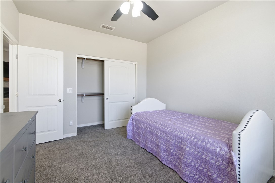 4713 North Old Ranch Lane Kingman, AZ 86401 - Photo 13 of 41 a bedroom with a bed and a chandelier