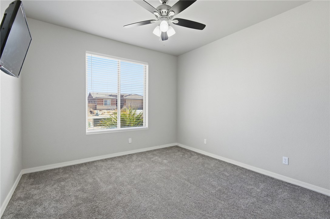 4713 North Old Ranch Lane Kingman, AZ 86401 - Photo 14 of 41 an empty room with a window and a fan
