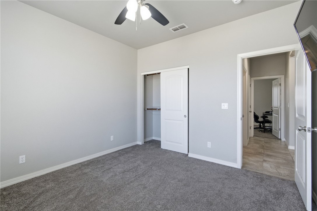 4713 North Old Ranch Lane Kingman, AZ 86401 - Photo 15 of 41 an empty room with closet and a ceiling fan