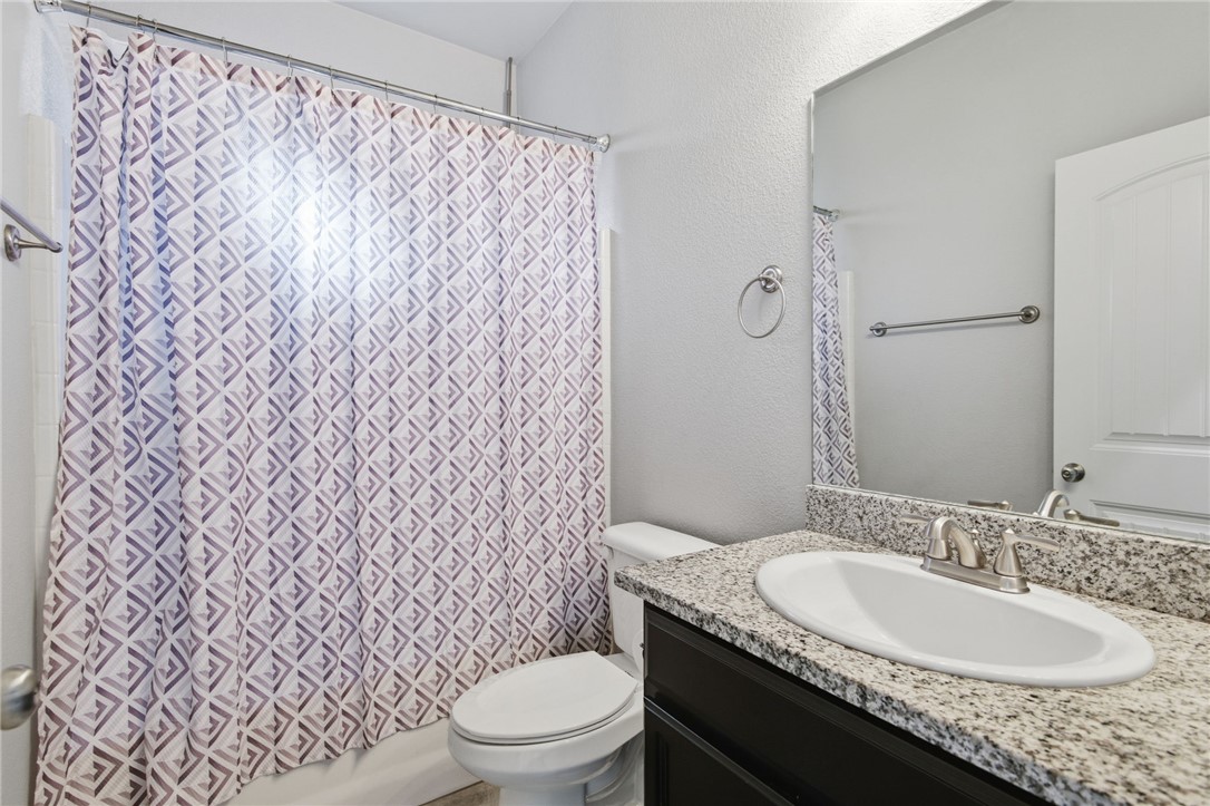 4713 North Old Ranch Lane Kingman, AZ 86401 - Photo 16 of 41 a bathroom with a granite countertop sink and a mirror