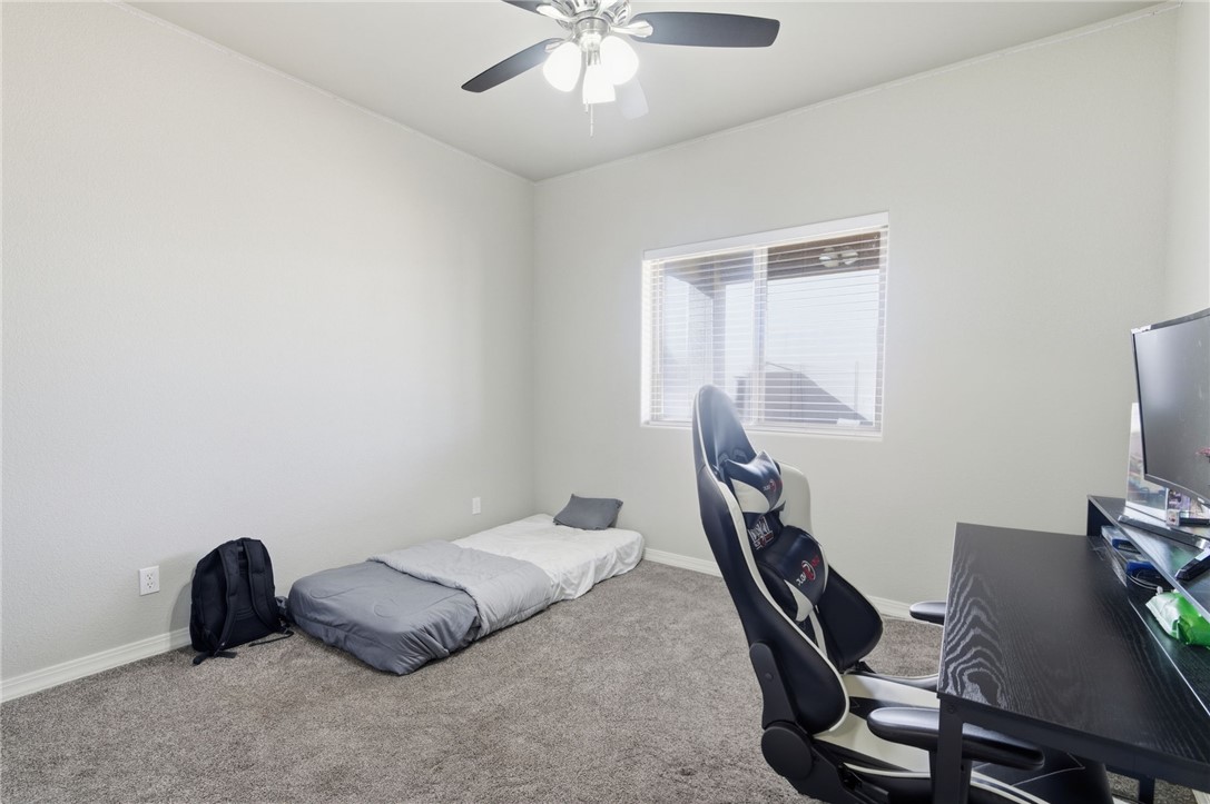4713 North Old Ranch Lane Kingman, AZ 86401 - Photo 17 of 41 a bedroom with a bed and a chandelier