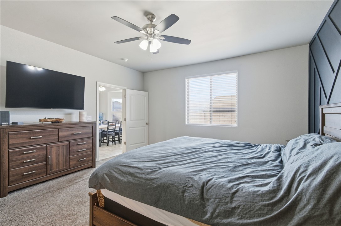 4713 North Old Ranch Lane Kingman, AZ 86401 - Photo 19 of 41 a bedroom with a large bed and a flat screen tv