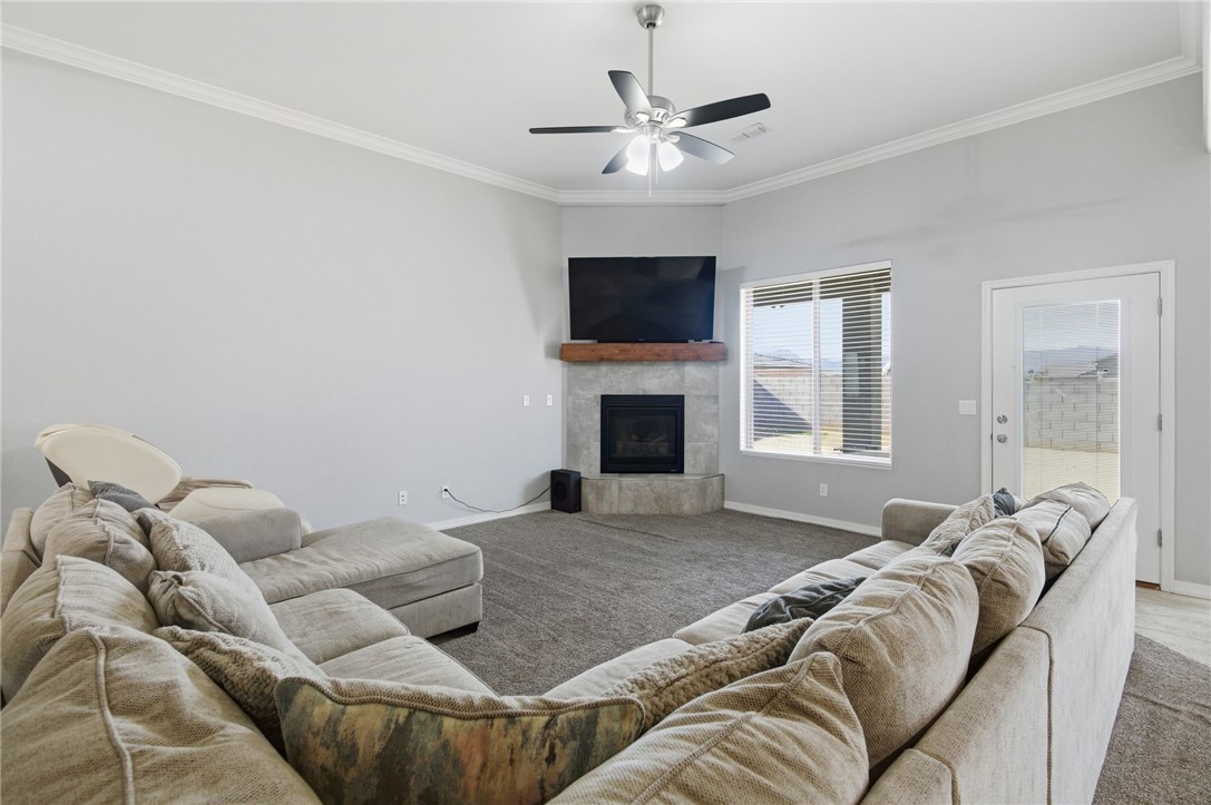 4713 North Old Ranch Lane Kingman, AZ 86401 - Photo 6 of 41 a living room with furniture a flat screen tv and a fireplace